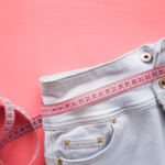 Shorts with a measuring tape showing weight loss